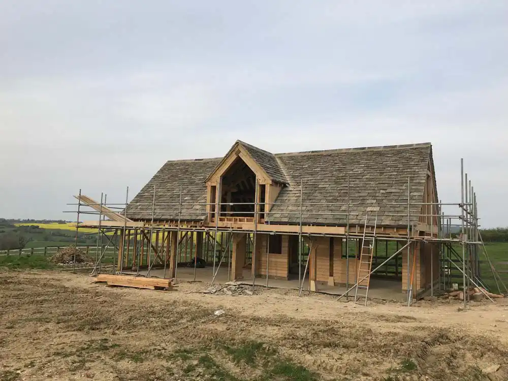 Oak framed garage with dormer under construction and scaffold in place